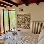 A House Between A Waterfall And A The Enchantment Of Nesso